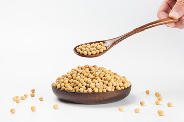 bowl of dried soybeans on white background
