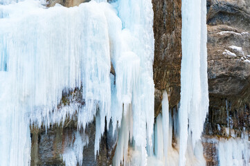 A frozen waterfall with ice in a blue and white color in winter