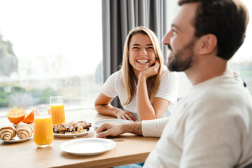 Beautiful happy couple eating their breakfast