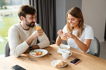 Beautiful happy couple eating their breakfast