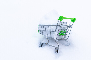 Green cart with snow inside on a white background.