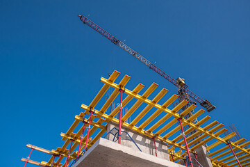 Horizontal formwork and crane at the construction of a residential building.