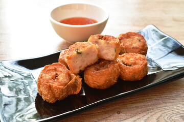 deep fried mashed crab meat and pork roll Chinese food on plate dipping sweet plum sauce