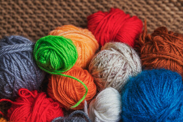 Fototapeta na wymiar Small balls of multicolored yarn for knitting.