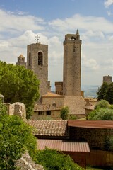 Fototapeta na wymiar View of the city skyline of San Gimignano in the background are typical stone houses and towers. It is popular summer travel destination, Europe, Italian