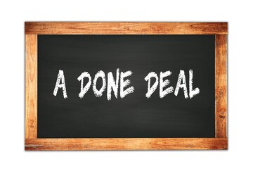 Obraz premium A DONE DEAL text written on wooden frame school blackboard.