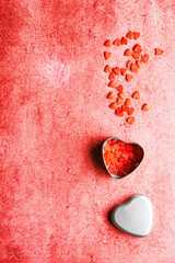 Valentine's day composition - candy hearts on red stone background. Love romantic concept. Flat lay, top view, copy space.