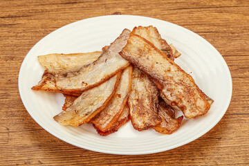 Roasted juicy bacon in the plate