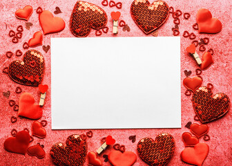 Valentine's day composition - Mockup white greeting card and various decorative red hearts on red stone background. Love romantic concept. Flat lay, top view, copy space.
