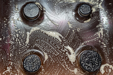 Cleaning the gas stove, washing the kitchen stove with foam