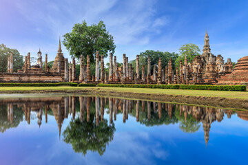 Fototapeta na wymiar Pagoda and ruined monastery complex at Wat Mahathat temple with reflection, Sukhothai Historical Park, Thailand