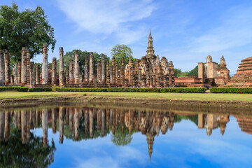 Fototapeta na wymiar Pagoda and ruined monastery complex at Wat Mahathat temple with reflection, Sukhothai Historical Park, Thailand