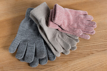Top view of cozy gloves on wooden surface