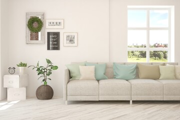 White living room with sofa and summer landscape in window. Scandinavian interior design. 3D illustration