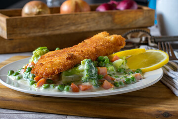 breaded fish with vegetable and sauce