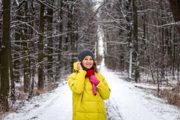 Fototapeta na wymiar Young woman wearing winter coat during walk in nature