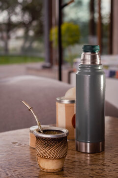 close-up of mat wood and yerba bulb and water at 80 degrees of hot temperature with thermos foam yerbera sugar bowl rustic wood base cordoba argentina