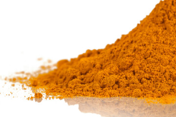 Heap of turmeric powder spice isolated on a white background.