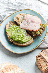 Ingredients for a healthy breakfast, nuts, oatmeal, honey, berries, fruits, blueberry, orange, pomegranate seeds, almonds, walnuts. The concept of natural organic food in season. Bread