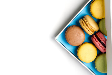 Colorful small macarons in the box with copy space