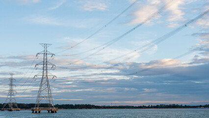 Electric poles are located at the sea in the Thai industrial area.