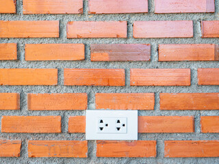 Power plug and brick wall .