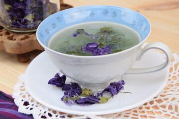 Mallow tea, herbal tea with dried mallow flowers in cup