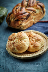 Sliced freshly baked mexican traditional pan de muerto with chocolate and cinnamon filling on a Oaxaca traditional barro negro pottery plate for the día de los muertos celebration on november 2nd
