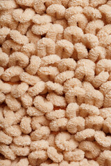 The structure of beige wool fibers in full screen as a background.