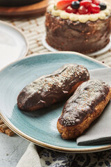 Traditional french eclairs with chocolate. Tasty dessert. Home made cake eclairs. Sweet. Dessert. Pastry filled with cream. Chocolate icing.