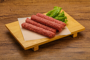 Raw beef sausages with spices