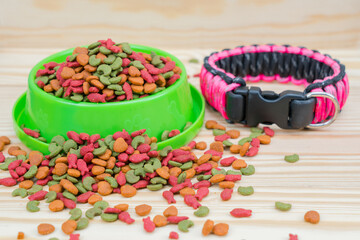 Pet food with dog collar on wooden background