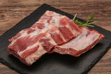 Raw pork ribs served rosemary