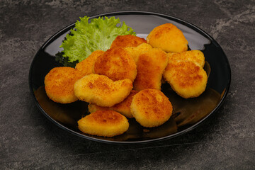 Fried chicken nuggets served salad leaves