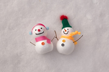 cute snowman standing on snowy field in winter.