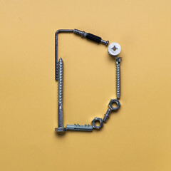 Alphabet letter D made of bolts, screws, typeset