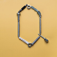 Alphabet letter Q made of bolts, screws, typeset
