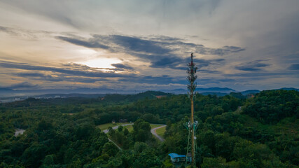 Obraz premium Aerial view of 5G Communication tower during beautiful sunrise with clouds