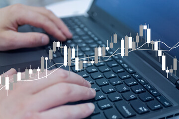 financial business analytics concept, candlestick chart, check market data and growth financial stock market graph on over blurred keyboard background