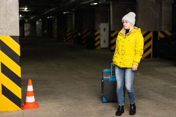 girl with bag in the parking at the airport