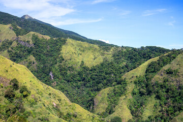 Naklejka premium Tropical island landscape with hills, mountains and trees. Volcanic island panoramic view. Natural hiking trail in Philippines. Summer natural parkland. South Asia ecotourism. Summer vacation outdoor