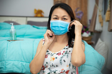 Coronavirus Asian woman patient coughing and wearing a medical mask To protect from 2019-nco virus and bacteria at home.Covid-19 Virus Protection concept.