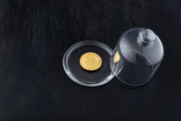 Bitcoin without glass cover. Bitcoin and bubble. Concept of instability of cryptocurrency and electronic money.