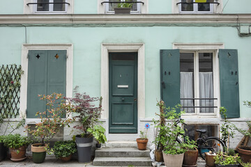 Obraz na płótnie Canvas Picturesque Cremieux Street (Rue Cremieux) in Paris Quinze-Vingts district - pedestrian and paved street, lined with small pavilions with colorful facades. PARIS, FRANCE.