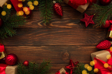 Christmas background with decorations, gift boxes and lights on wooden table. Top view. Copy space....