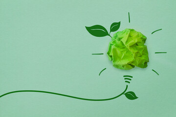 eco-friendly business concept with crumpled yellow paper light bulb 