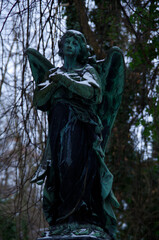 Tombstones and graves, family crypts and vaults on graveyard or cemetery with angels, saints and...