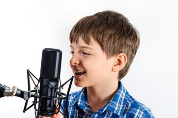 Kid in plaid shirt laughs in microphone