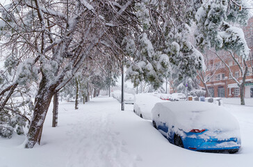 Streets and buildings covered in snow by day due to snowstorm Filomena falling in Madrid Spain
