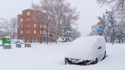 Streets and buildings covered in snow by day due to snowstorm Filomena falling in Madrid Spain
